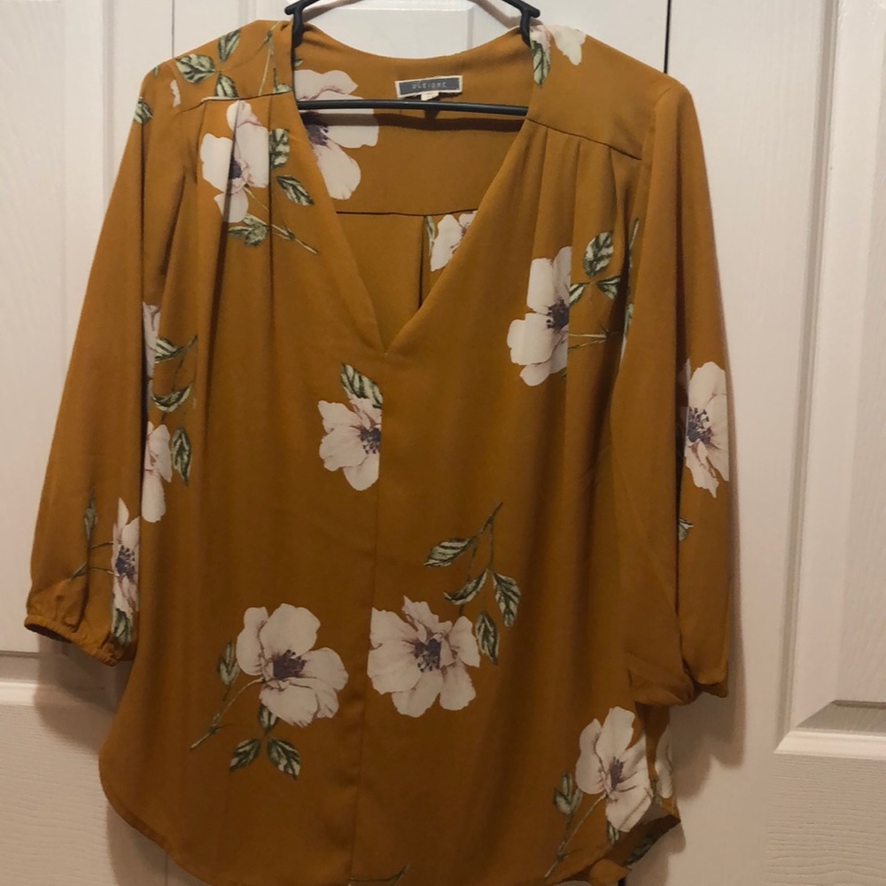 Mustard colored floral blouse.